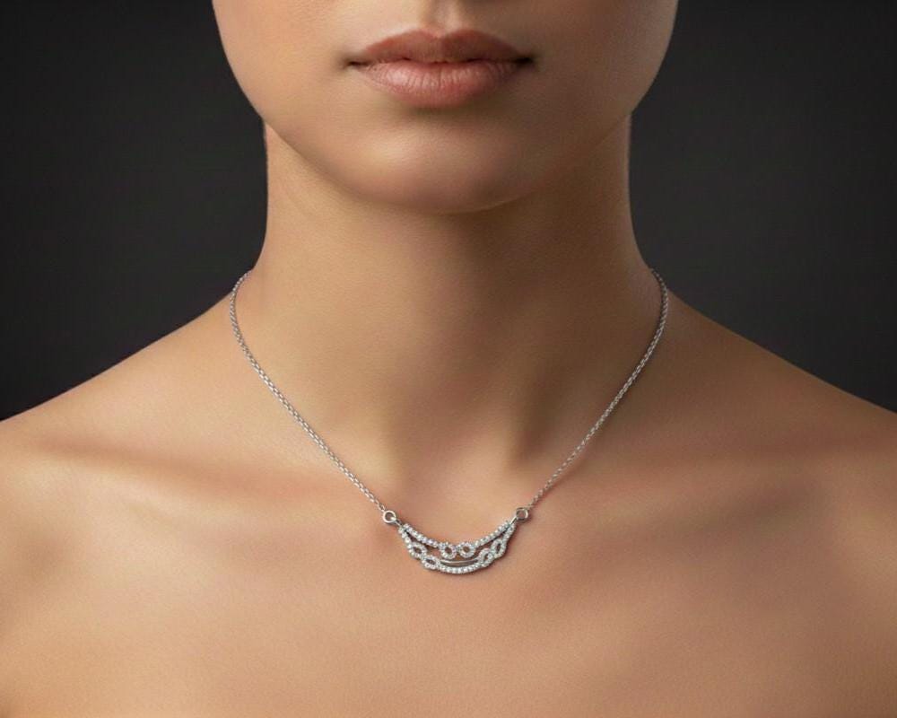 Dainty layered gold moissanite diamond necklace with minimalist double chain, perfect for everyday wear or gifting.