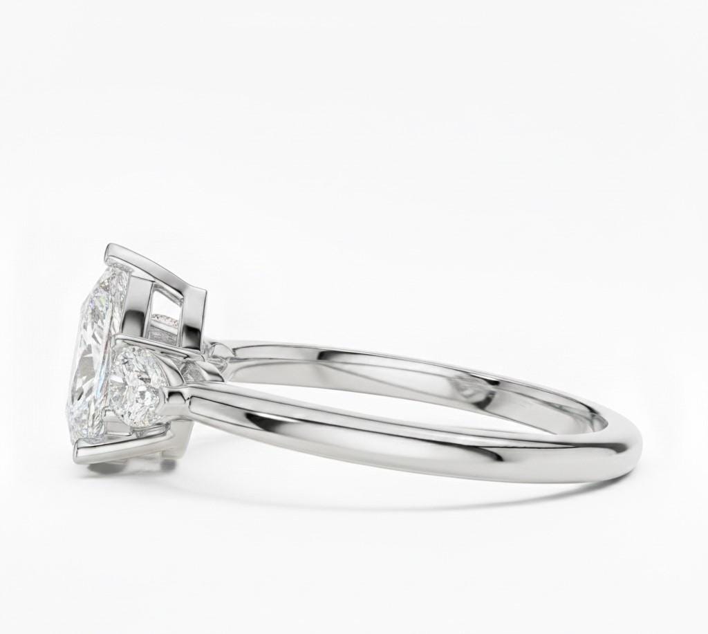 Pear cut cubic zirconia engagement ring by Riora in gold and silver, showcasing the sparkling gemstone on a delicate band.