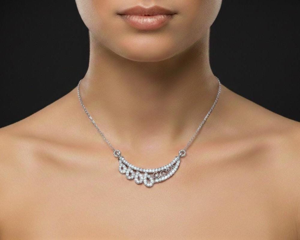 Rose gold moissanite teardrop necklace featuring an elegant bridal pendant, perfect wedding jewelry for her.
