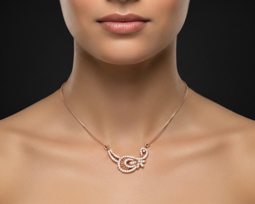 Gold moissanite leaf necklace by Riora featuring a delicate, minimalist design perfect for bridal jewelry or special occasions.