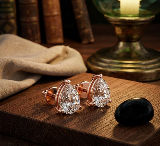 Pear cut moissanite diamond stud earrings in rose gold with minimalist teardrop design, perfect for bridal or wedding jewelry.