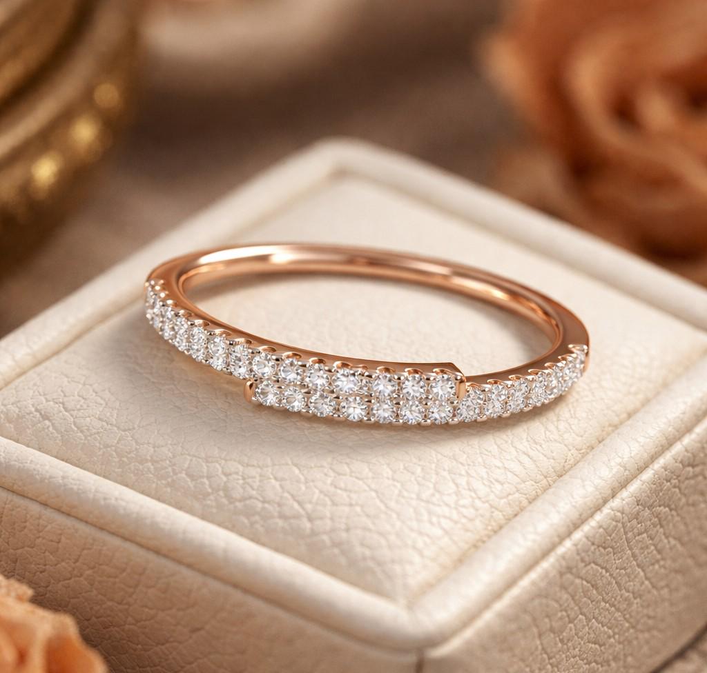 Rose gold moissanite curved wedding band with half eternity diamond style, minimalist stacking ring from Riora.
