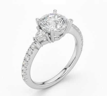 Elegant CZ engagement ring with gold, rose, and silver tones from Riora, featuring a sparkling central stone and delicate band.