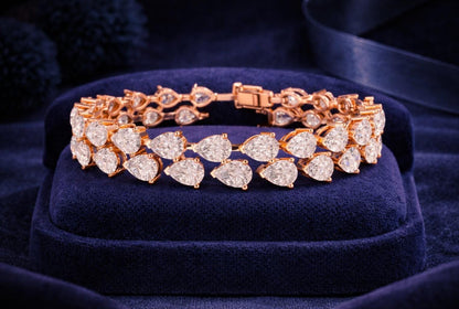 Pear cut moissanite diamond tennis bracelet in rose gold, showcasing elegant, dainty bridal jewelry with sparkling gemstones.