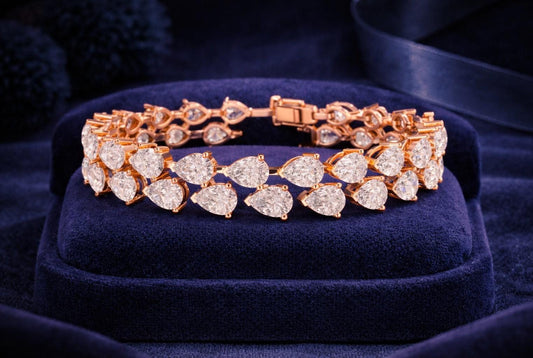 Pear cut moissanite diamond tennis bracelet in rose gold, showcasing elegant, dainty bridal jewelry with sparkling gemstones.