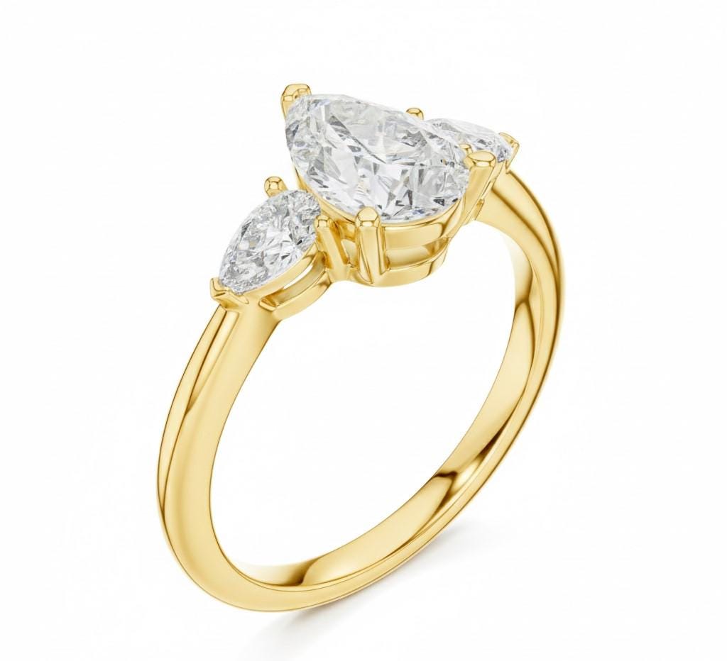Pear cut cubic zirconia engagement ring by Riora in gold or silver, hypoallergenic and lead-free, ideal as a bridal promise gift.
