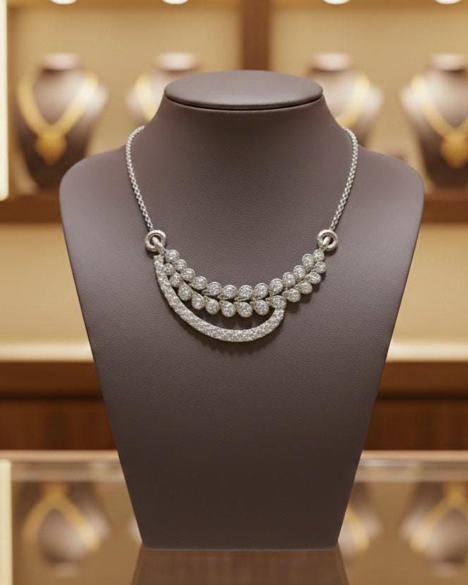 Elegant moissanite leaf necklace by Riora featuring gold and silver tones, perfect for bridal or minimalist wedding jewelry.
