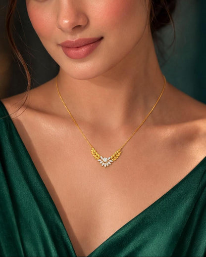 Riora Moissanite Laurel Leaf Necklace in gold and rose gold, minimalist bridal pendant with diamond-style sparkle on a chain