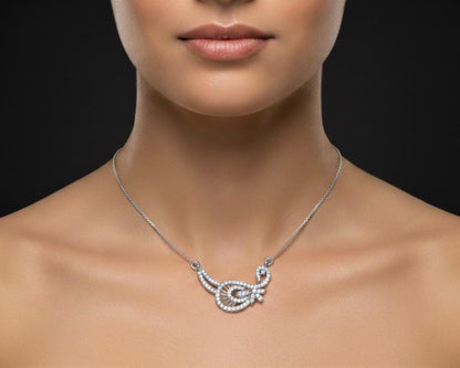 Gold moissanite leaf necklace by Riora featuring a delicate, minimalist design perfect for bridal or wedding jewelry.