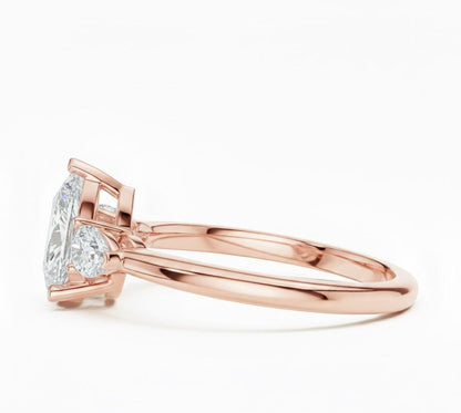 Pear cut cubic zirconia engagement ring in gold and silver by Riora, featuring a sparkling center stone and hypoallergenic design.