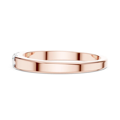 Riora rose gold minimalist moissanite wedding band with stackable promise ring design for women, featuring small sparkling diamonds.