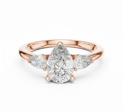 Pear cut cubic zirconia engagement ring by Riora in gold and silver, featuring a sparkling gemstone and elegant band design.