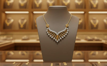 Gold necklace on a mannequin bust with a jewelry store background