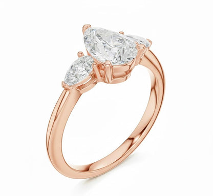Pear cut cubic zirconia engagement ring in gold and silver by Riora, featuring a sparkling central stone and a sleek band.