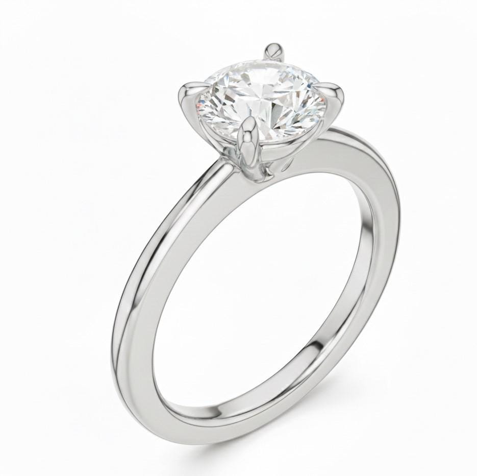 Riora minimalist gold moissanite diamond solitaire ring with a dainty thin band, perfect for stacking or as a wedding promise ring.