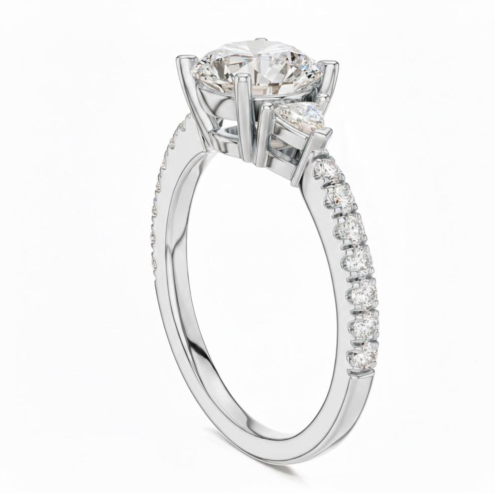 Elegant rose gold and silver CZ engagement ring by Riora featuring a sparkling solitaire stone and intricate band design.