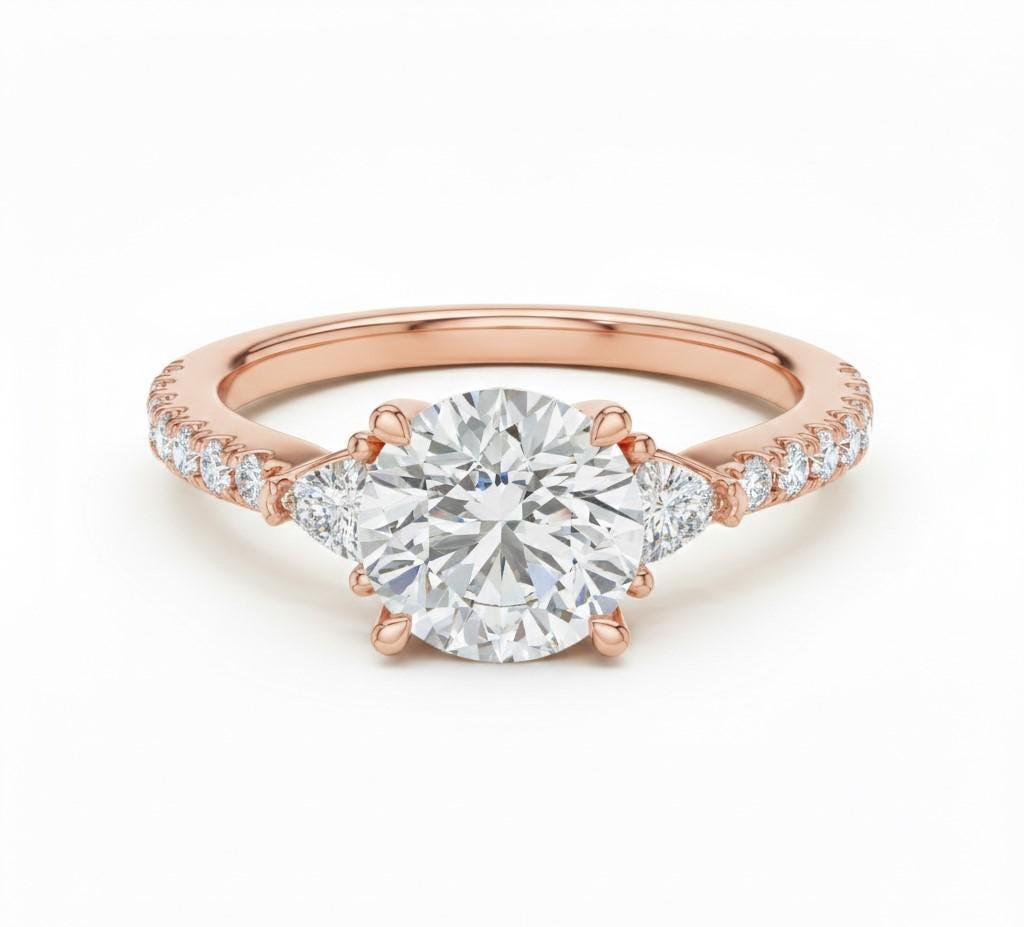 Elegant CZ engagement ring by Riora featuring gold, rose, and silver tones with a sparkling bridal design and hypoallergenic finish.