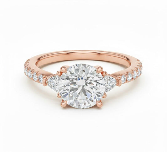 Elegant CZ engagement ring by Riora featuring gold, rose, and silver tones with a sparkling bridal design and hypoallergenic finish.