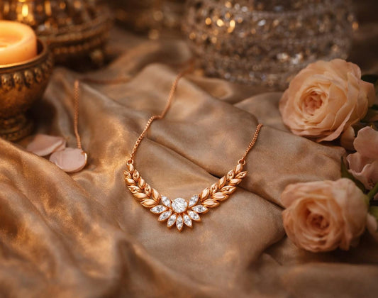Riora moissanite laurel leaf necklace in gold and rose gold, minimalist bridal pendant with diamond-style sparkle on a white background.