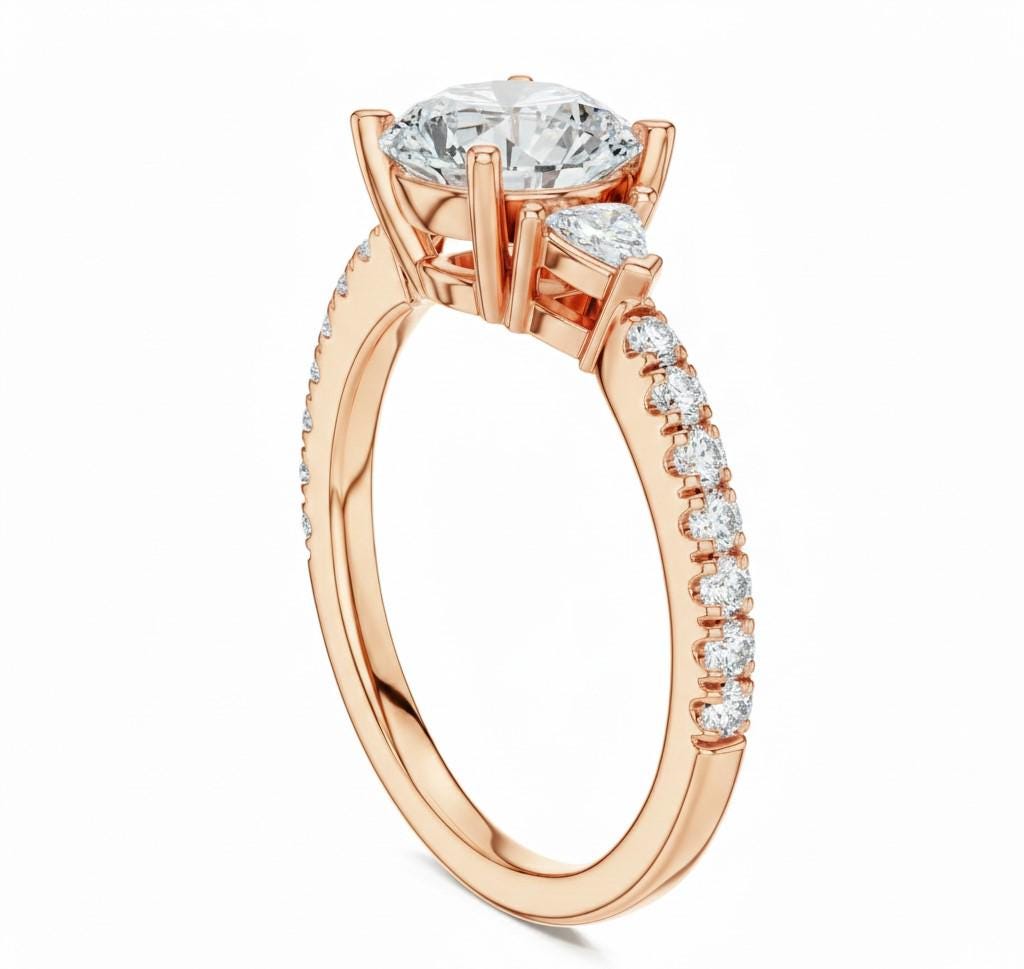 Elegant CZ engagement ring by Riora featuring gold, rose, and silver tones, perfect for bridal and wedding jewelry.