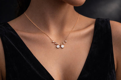 Riora Moissanite cherry branch necklace with leaf pendant in rose gold and silver, minimalist nature-inspired bridal jewelry.