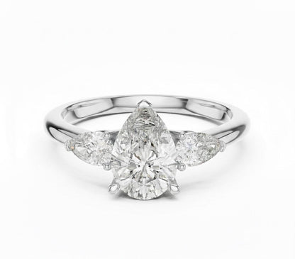Pear cut cubic zirconia engagement ring by Riora in gold or silver, showcasing a sparkling gemstone set in a sleek band.