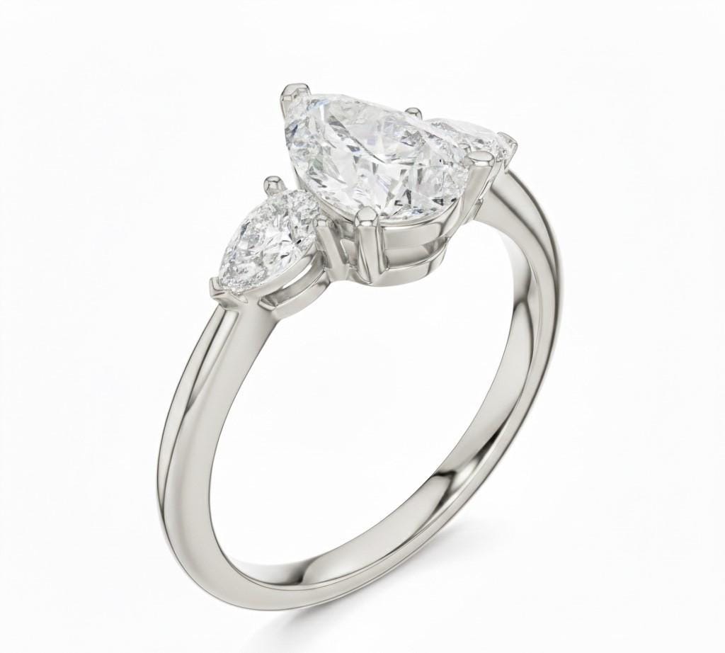 Pear cut cubic zirconia engagement ring by Riora in gold and silver with a delicate band, hypoallergenic and lead-free bridal jewelry