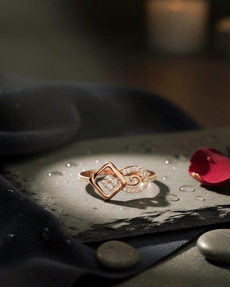 Rose gold geometric swirl moissanite diamond ring by Riora, minimalist modern jewelry for engagement or promise occasions.