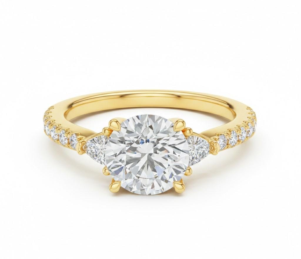 Riora elegant CZ engagement ring with gold, rose, and silver tones featuring a sparkling central stone on a delicate band.